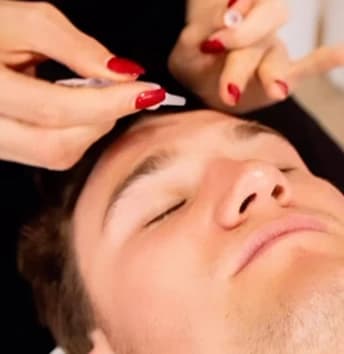 Lida's expert hands during a facial treatment